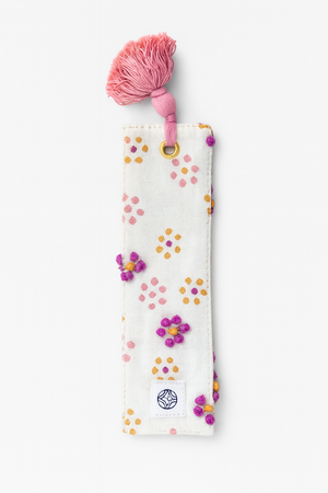 Decorative bookmark with colorful French knots and a pink tassel on a white background