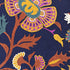 Decorative fabric with pink, yellow, rust, teal, and white hued paisley pattern on a dark blue background