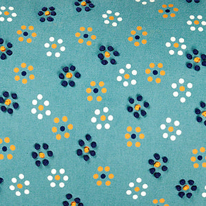 Teal embroidered throw pillow with polka-dotted floral motif and French knot accents