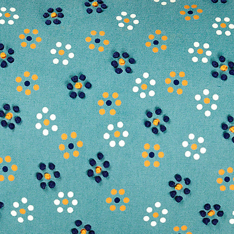 Teal embroidered throw pillow with polka-dotted floral motif and French knot accents