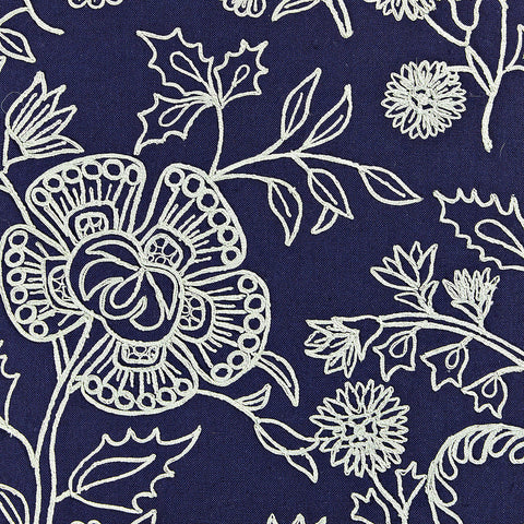 Square throw pillow in navy and light blue hues with a flowing floral design.