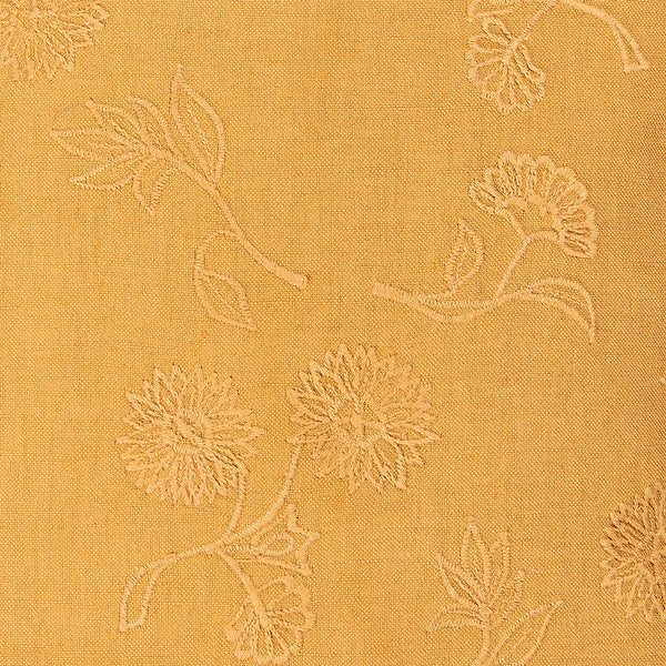Textured fabric with floral pattern on a mustard yellow background