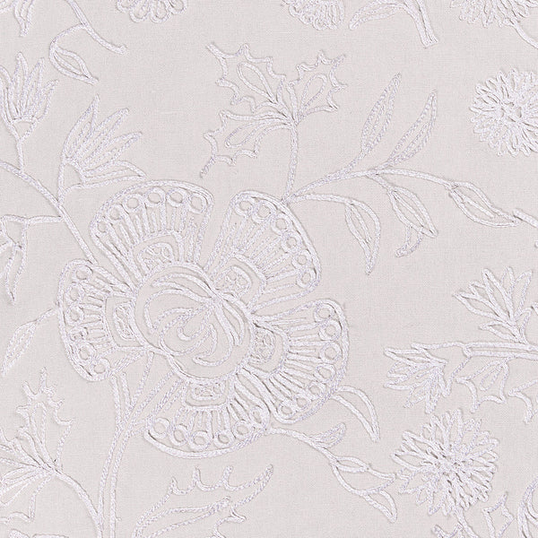 Tonal white paisley throw pillow with white embroidery.